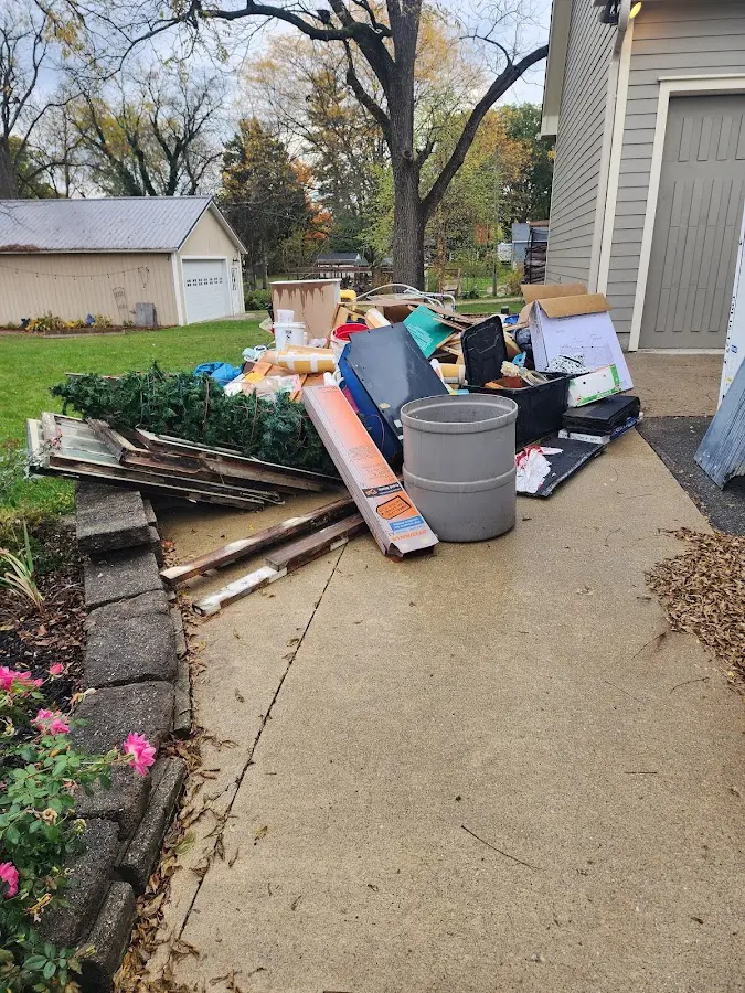 Dumpster being loaded with debris for Residential Dumpster Rental in Bowne